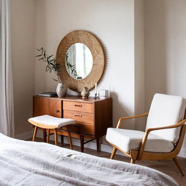 vintage carved wooden round mirror on the wall