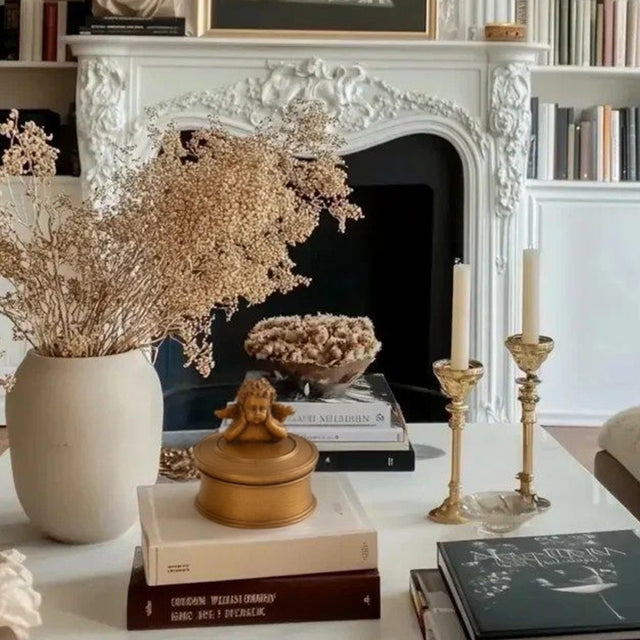 vintage gold round resin cherub trinket box on coffee table