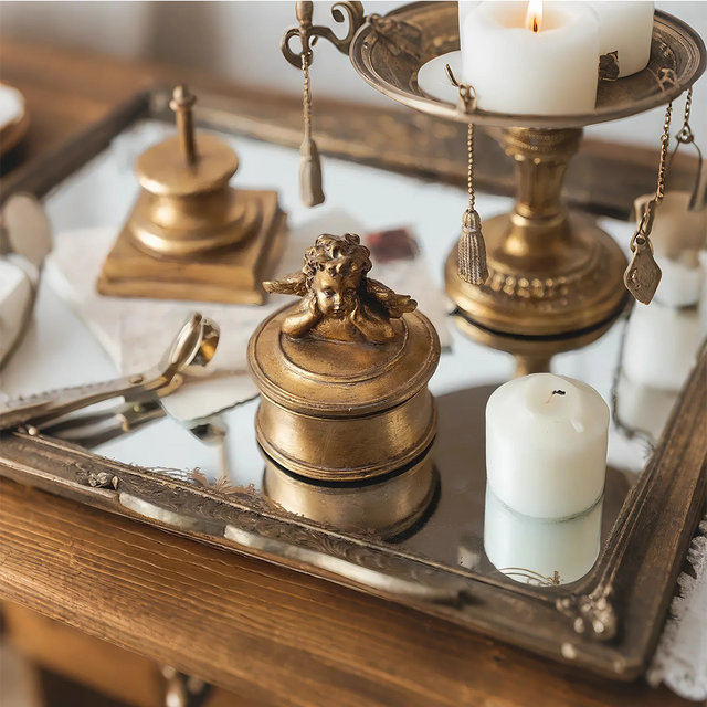 vintage gold round resin cherub trinket box on the tray