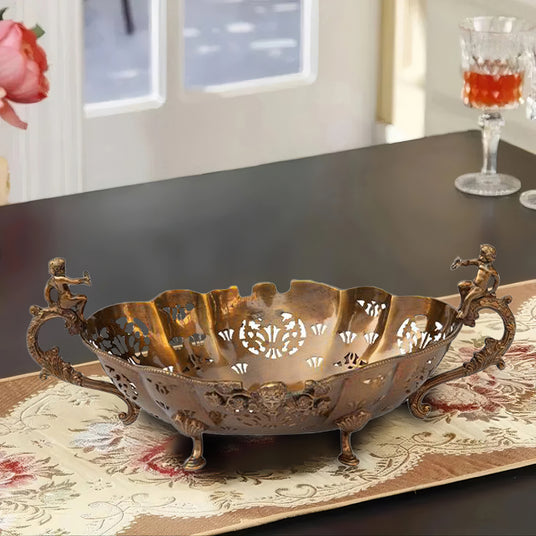 vintage hollow-out brass fruit plate with handles on the table