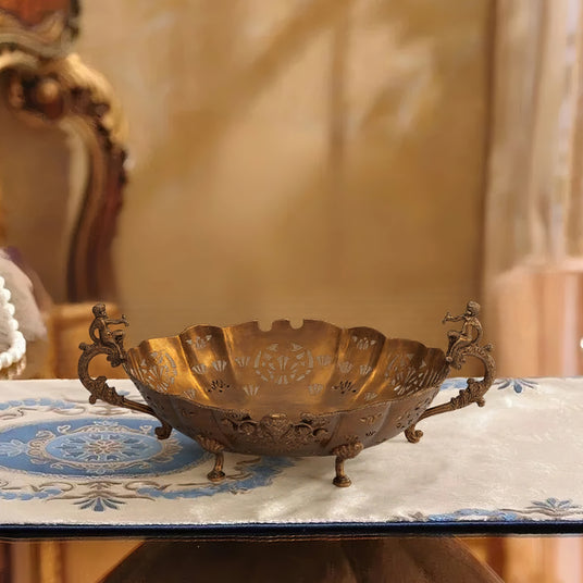 vintage hollow-out brass fruit plate with handles on the tabletop
