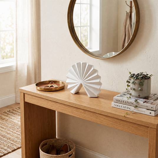 white fan sculpture on wooden console with mirror and keys