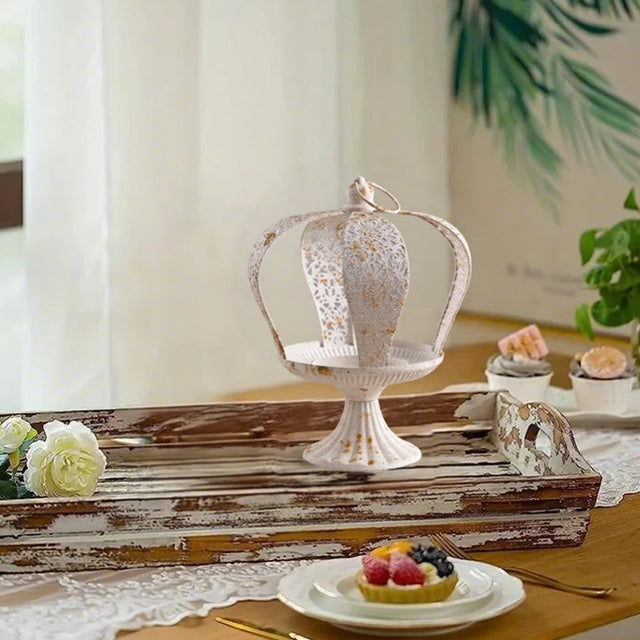 white metal crown hurricane candle holder on a wood tray
