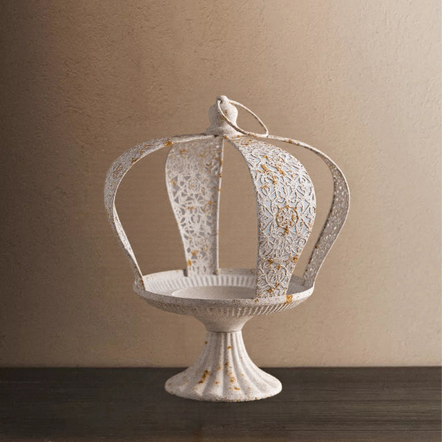 white metal crown hurricane candle holder on the table