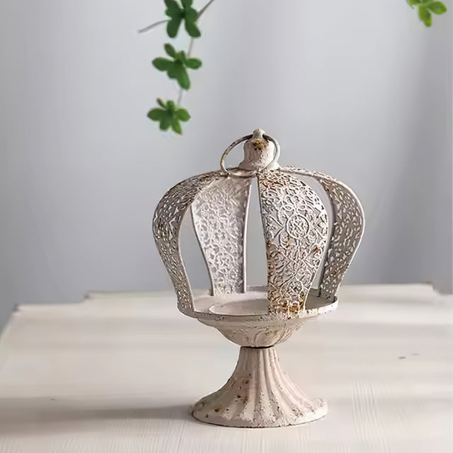 white metal crown hurricane candle holder on the table