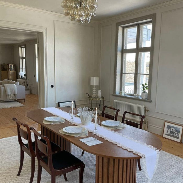 white satin lace table runner on a table