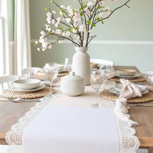 white satin lace table runner on a wood table