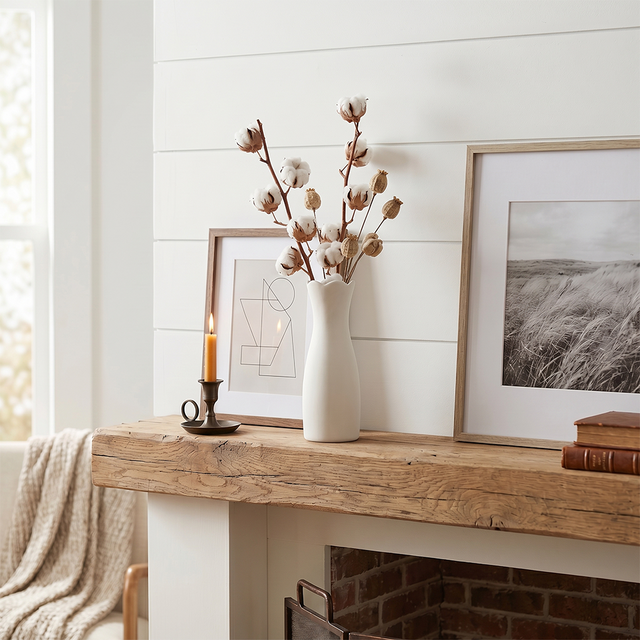 white vase with cotton on mantel