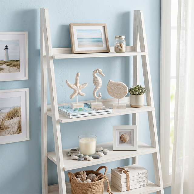 wood figurines on white leaning ladder shelf