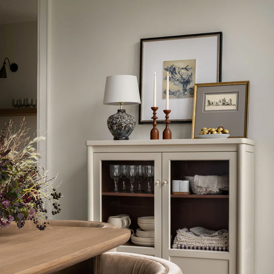wooden brown decorative candle holder on the cabinet