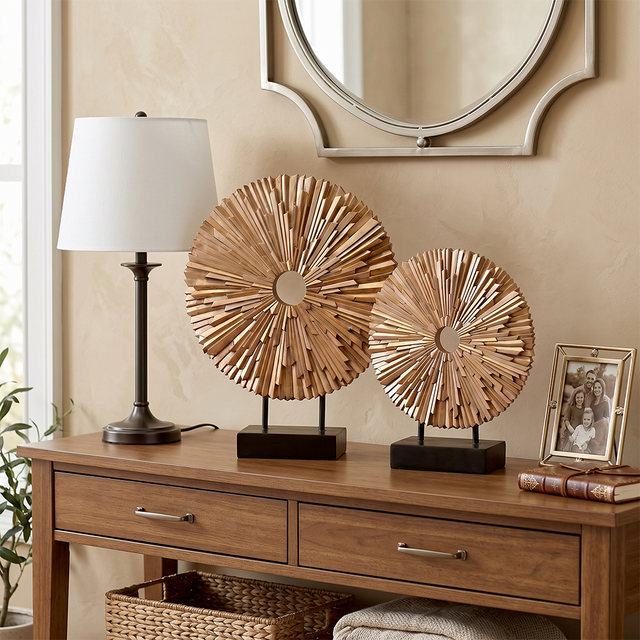 wooden sunburst sculptures on console with lamp