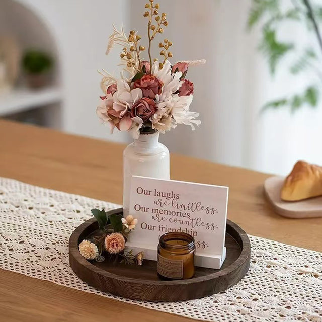 wooden tray holding candle and flowers