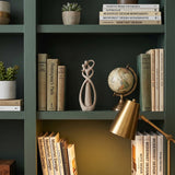 Abstract Couple Sculpture On Green Bookshelf