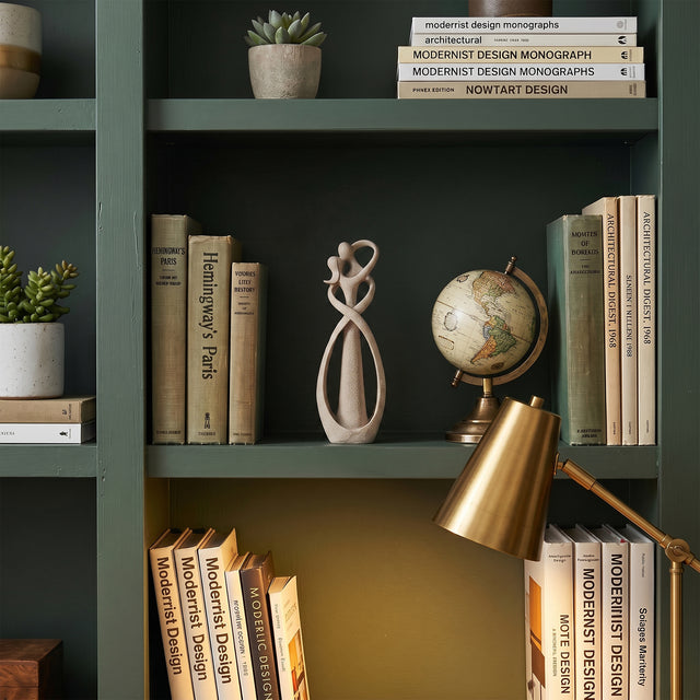 Abstract Couple Sculpture On Green Bookshelf
