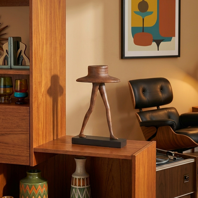 Abstract leg sculpture on-wood-side-cabinet