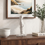Abstract stone figurine on rustic wood console