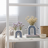 Arch ceramics displayed on storage shelf
