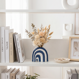 Arch vase decoration on book shelf
