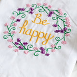 Be happy wreath napkin closeup
