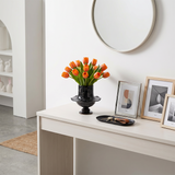 Black flared vase on minimalist white entry table