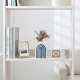 Blue arch crafts on white display shelf