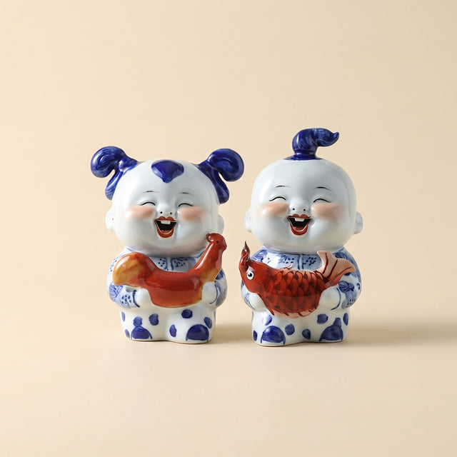 Blue white ceramic kid fish statue pair