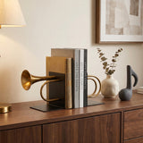 Brass trumpet bookends on wood entry sideboard