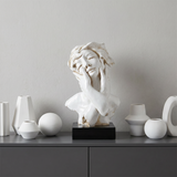 Bust statue displayed on gray cabinet