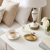 Butterfly ring plate on cream bedside table