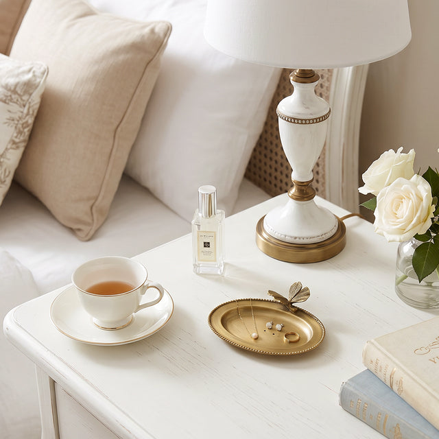 Butterfly ring plate on cream bedside table