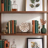 Carved stone plaque displayed inside open wood bookcase