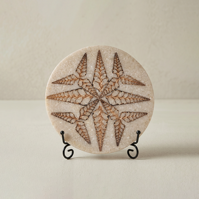 Carved stone round plaque with black metal display stand