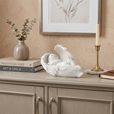 Cherub statue displayed on side cabinet
