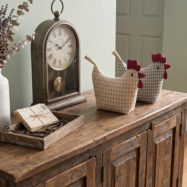 Chickens displayed on wood cabinet
