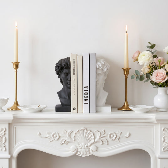 Classical bookends placed on vintage fireplace