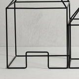 Closeup M metal wire house
