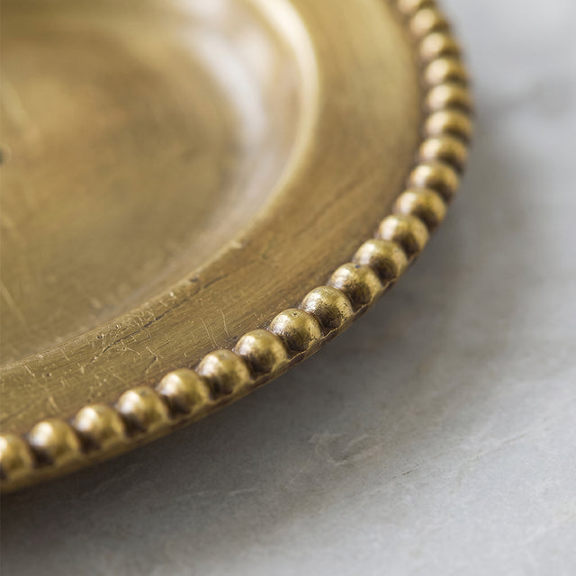 Closeup beaded edge brass tray