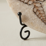 Closeup curved black metal stand hook detail