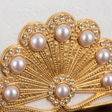 Closeup pearl encrusted gold fan top