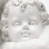 Closeup sleeping cherub face carving