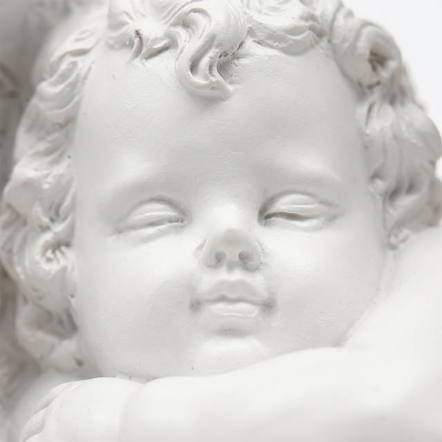 Closeup sleeping cherub face carving