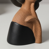 Closeup textured  brown and black figurine torso