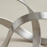 Closeup wide silver band intertwined rings