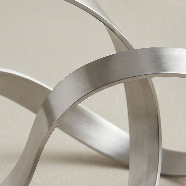 Closeup wide silver band intertwined rings