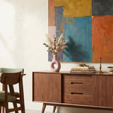 Donut ceramic vase on wood sideboard