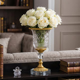 Flower filled glass vase on living side table