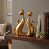 Gold Cat Sculptures On Wooden Shelf