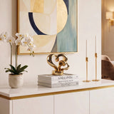 Gold Heart Sculpture On White Console