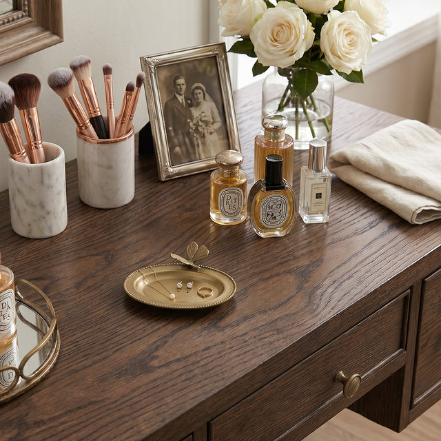 Golden butterfly dish on dark vanity tabletop