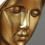 Golden female face carving close shot